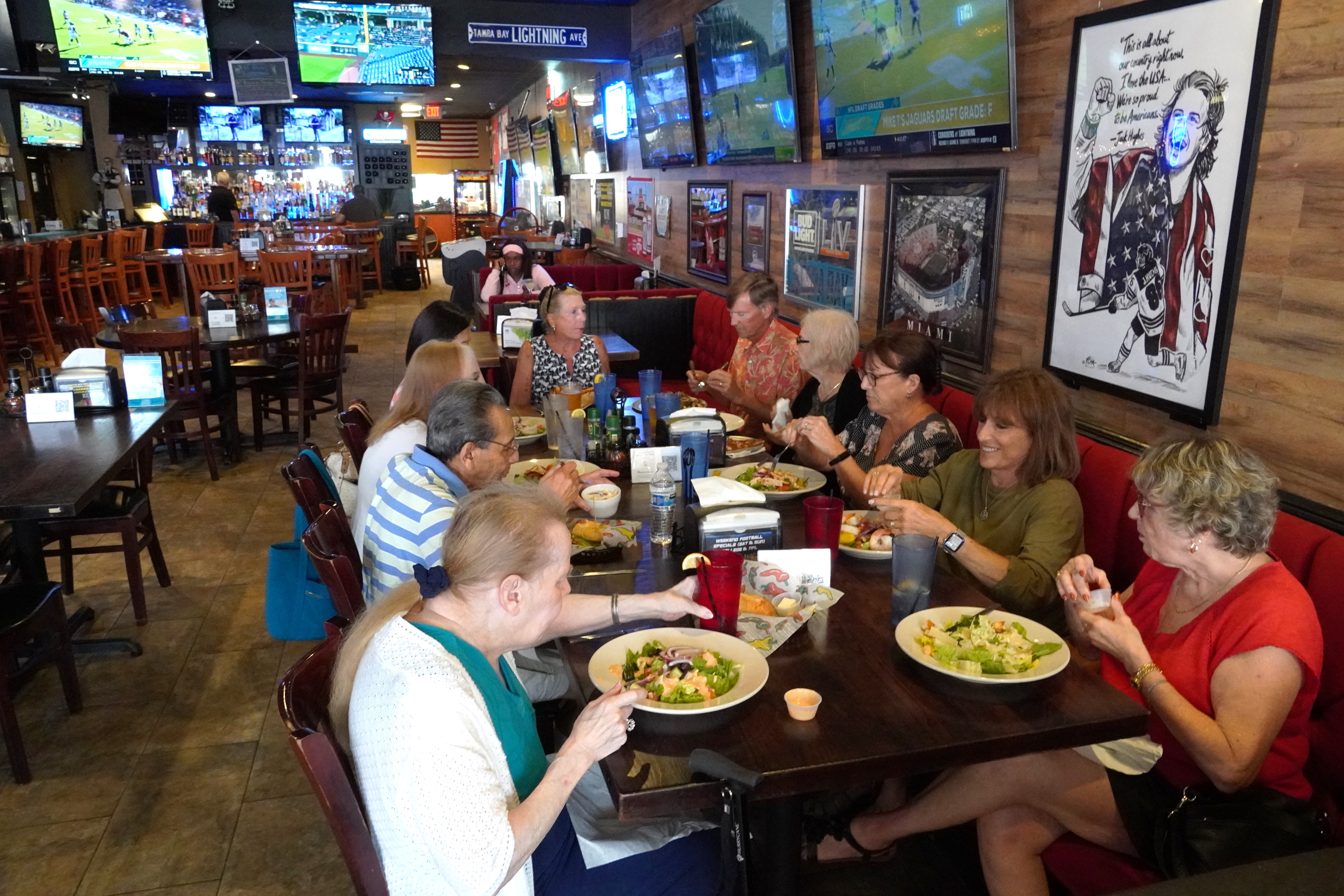 A group of friends dine at Downtown Pizza Sports Bar and Grille